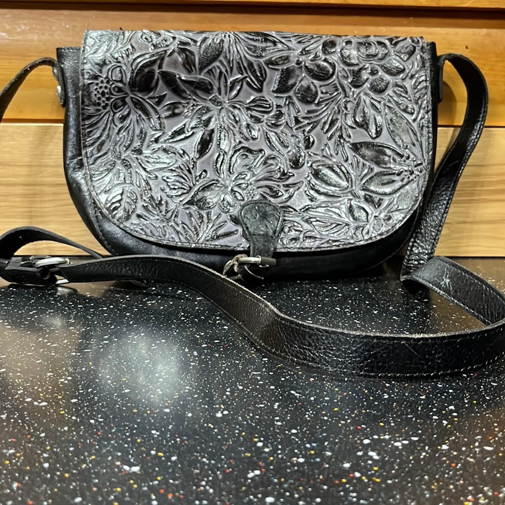 Black purse with gray black flower design